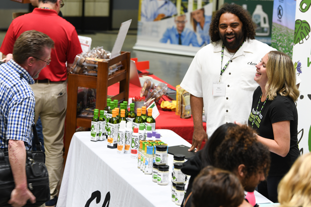 People laughing at the conference Vendor Showcase